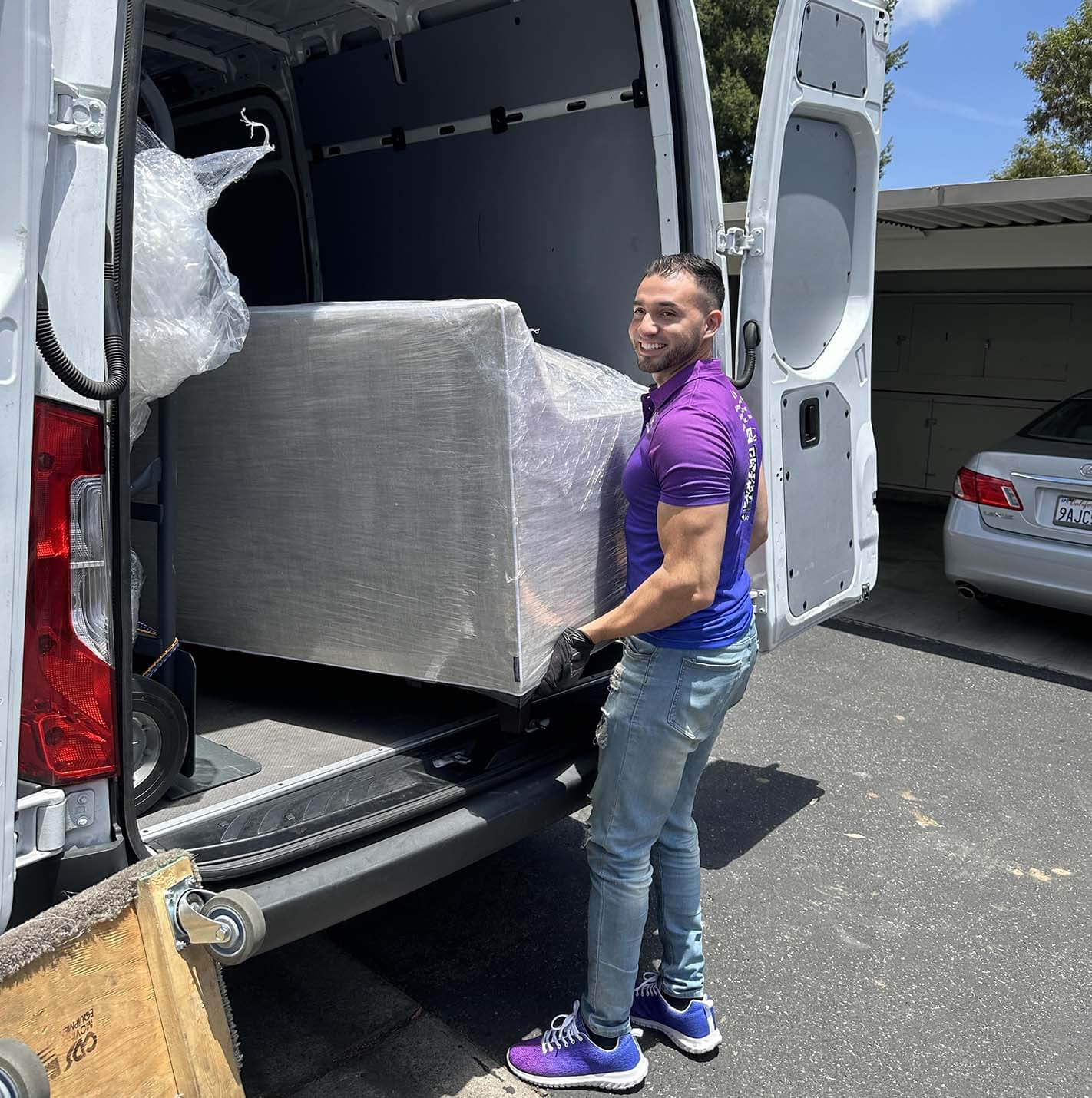 On-the-job image of Rico by van or loading furniture